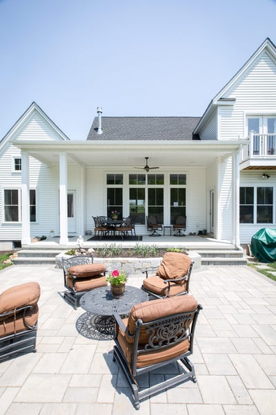 Stone Patio and Beautiful View of the Back Exterior of the Home  | Sunwood Home Builders & Remodelers