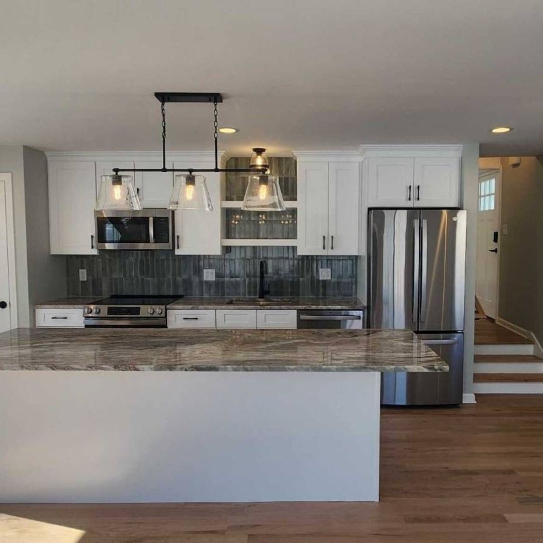 BLiving space with a central fireplace flanked by large windows overlooking a snowy lake | Sunwood