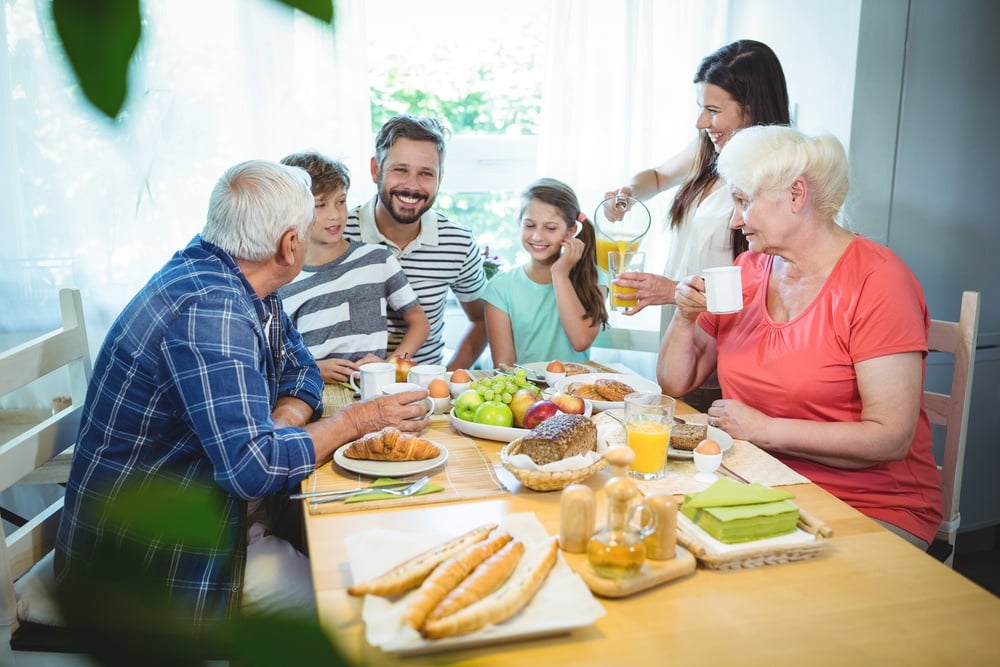 Happy multi-generation family sitting at breakfast table.jpeg