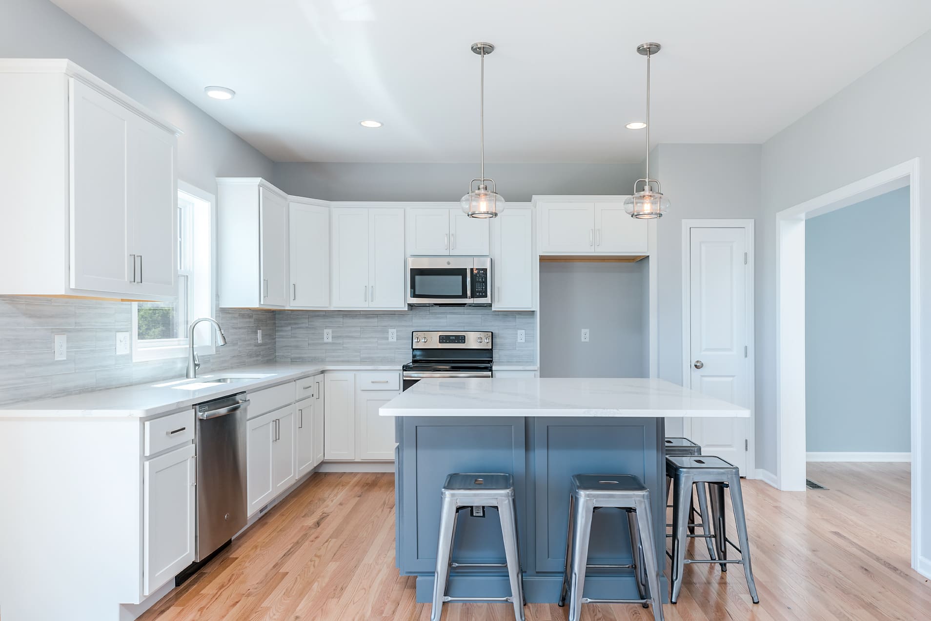 Beautiful Remodeled Kitchen with White Cabinetry and Large Kitchen Island  | Sunwood Home Builders & Remodelers